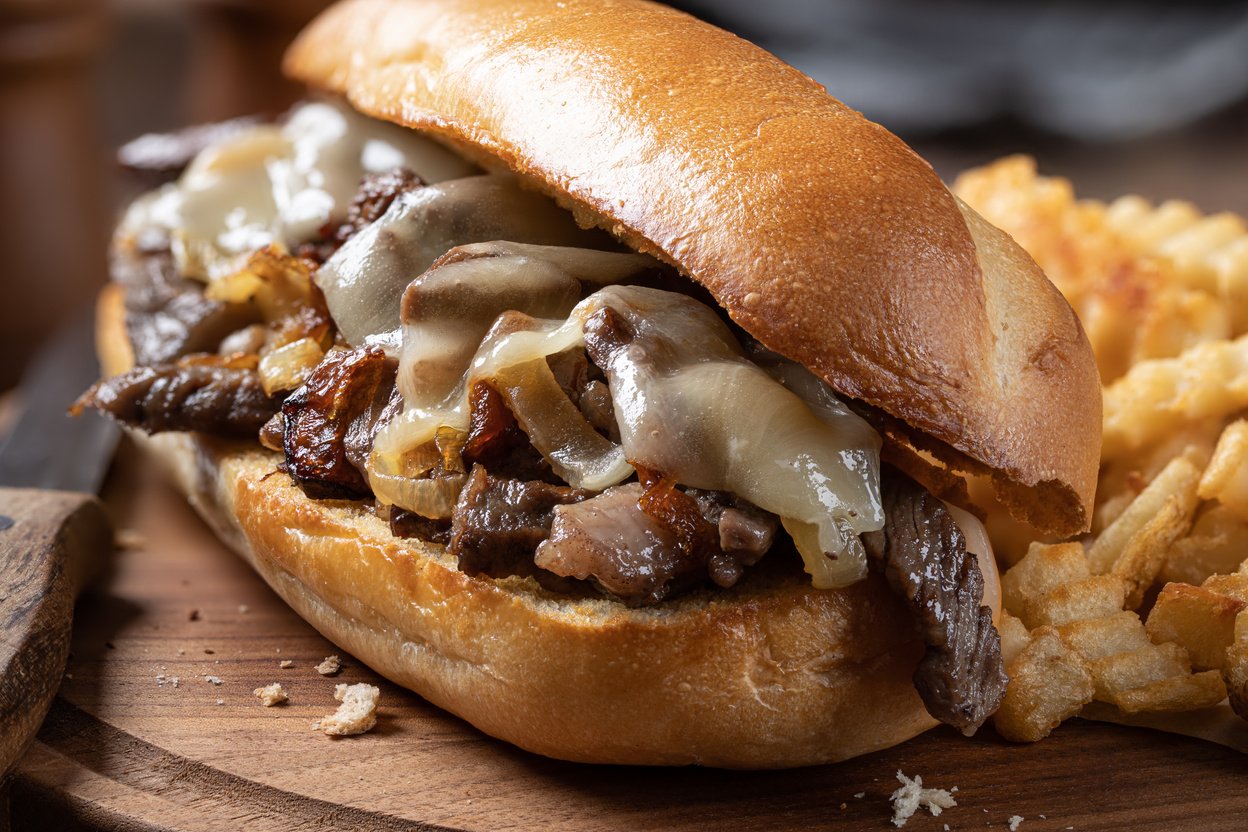 Philly cheesesteak sandwich and french fries